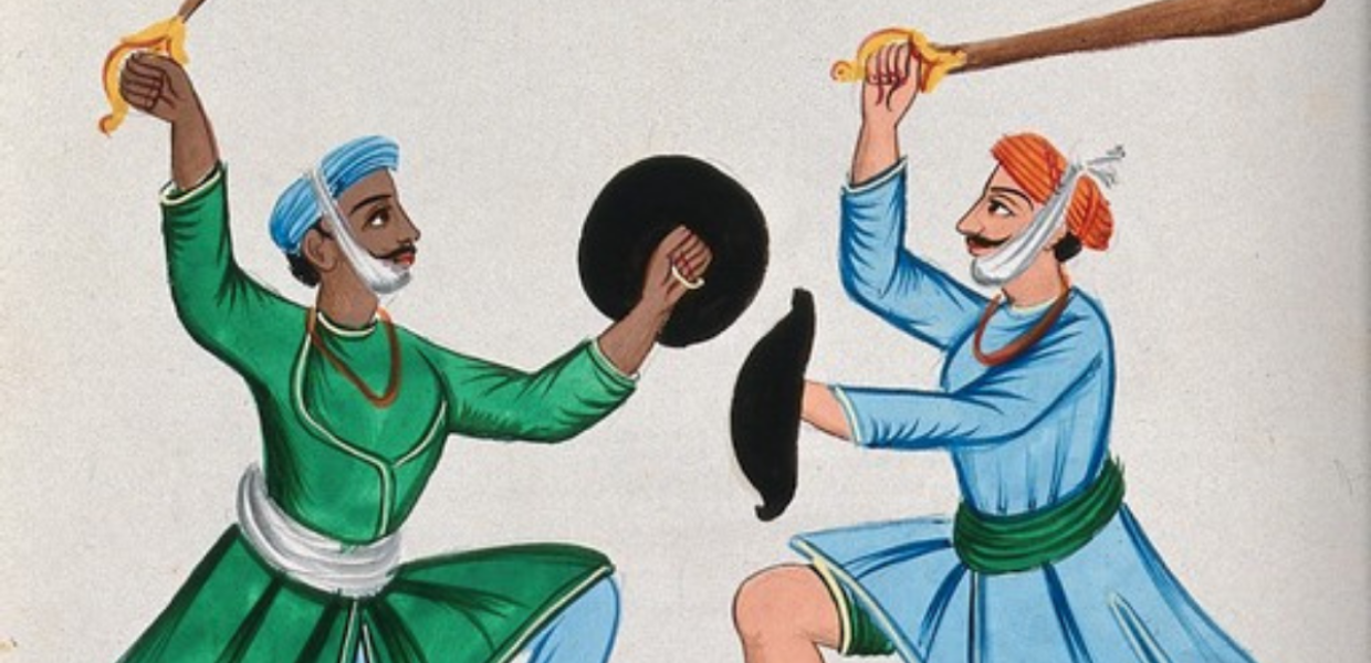 Two Sikh men dueling with wooden swords.
